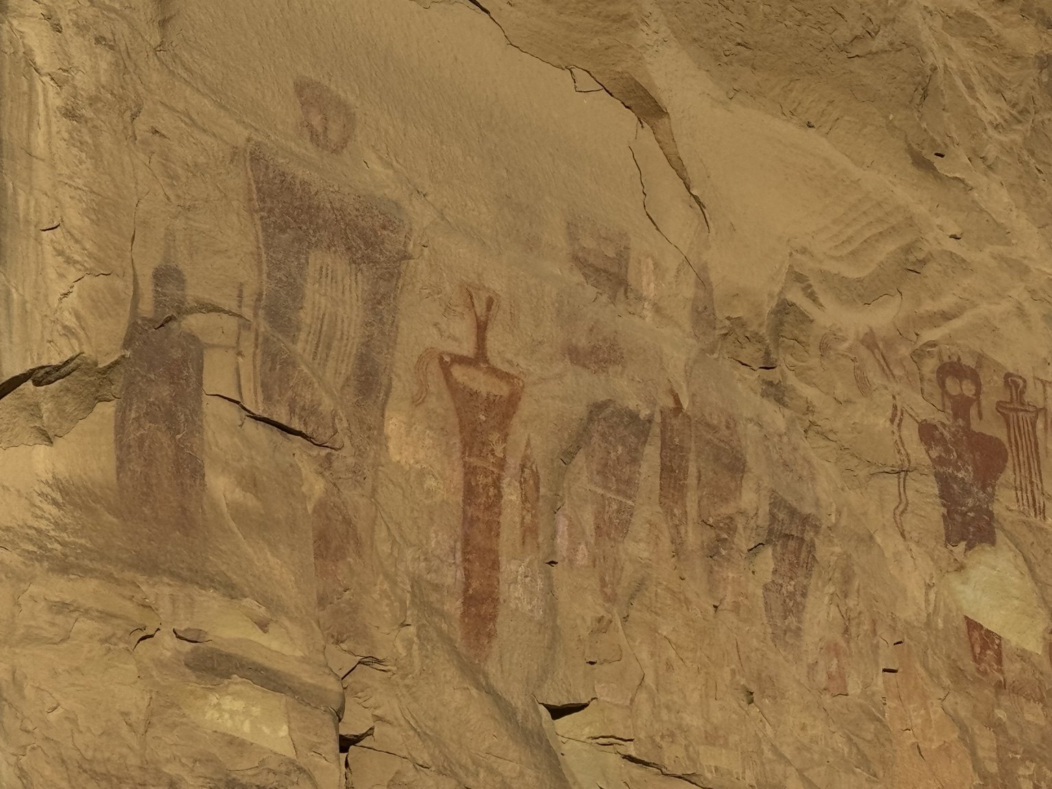 Wide view of elongated anthropomorphic rock art figures